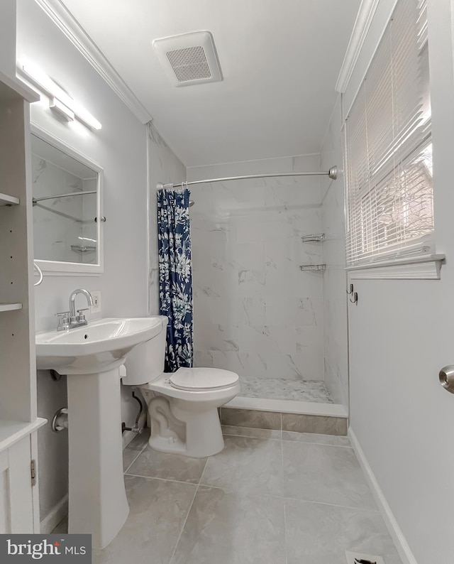 bathroom featuring crown molding, toilet, and walk in shower