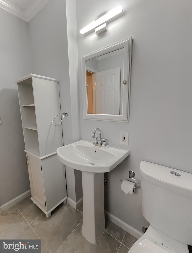 bathroom featuring tile patterned flooring, toilet, and ornamental molding