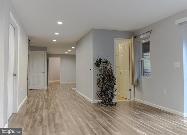 hall with light hardwood / wood-style floors