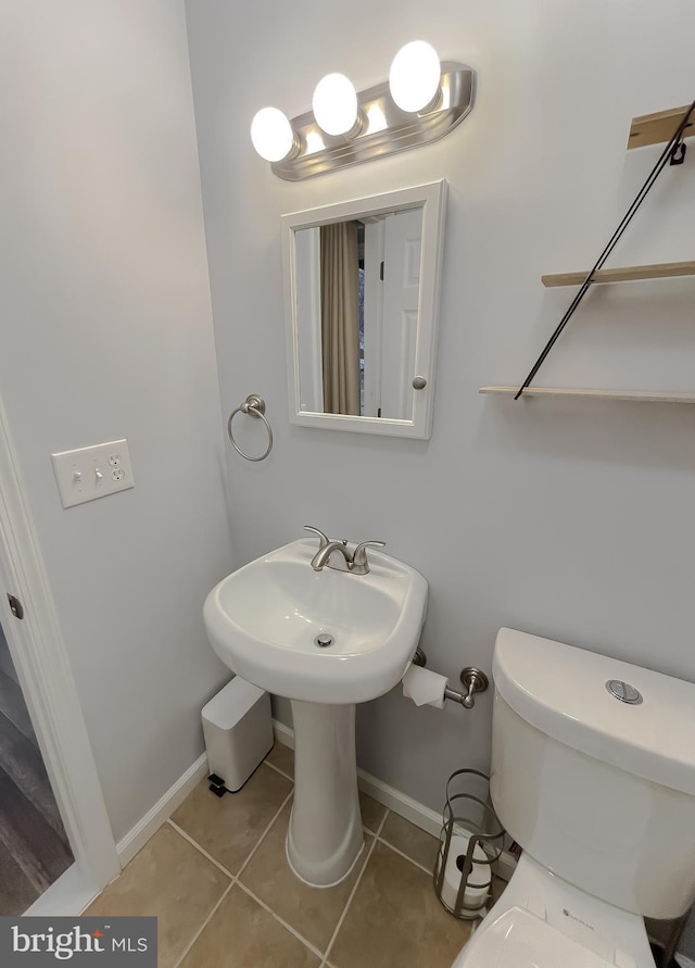 bathroom featuring tile patterned flooring and toilet