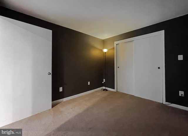 unfurnished bedroom featuring a closet and carpet