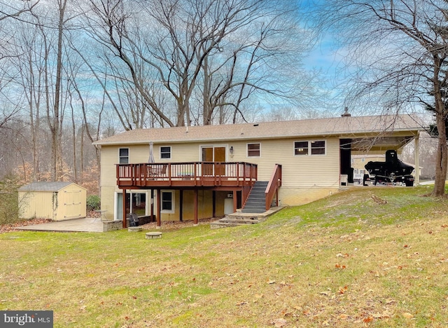 rear view of property with a yard, a storage shed, and a wooden deck