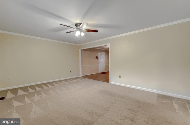 spare room featuring carpet flooring, ceiling fan, and ornamental molding