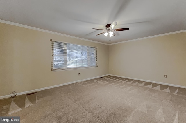 unfurnished room featuring ceiling fan, light colored carpet, and crown molding