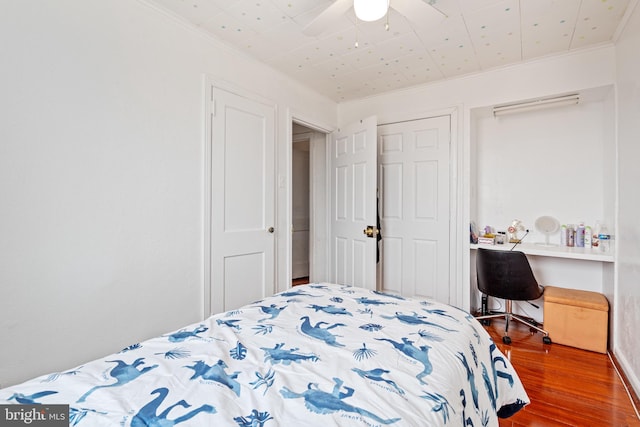 bedroom with ceiling fan, wood-type flooring, and ornamental molding