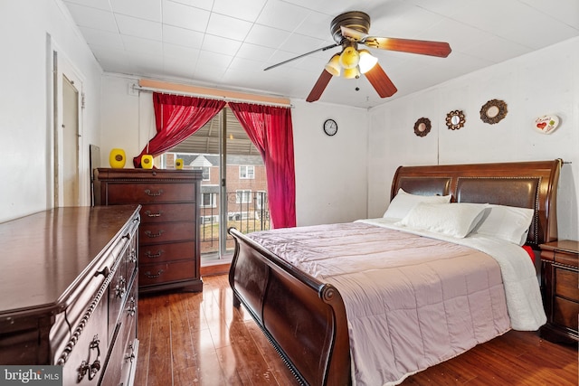 bedroom with dark hardwood / wood-style floors, ceiling fan, and access to outside