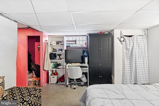 carpeted bedroom with a paneled ceiling