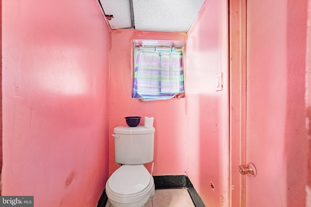 bathroom featuring a textured ceiling and toilet