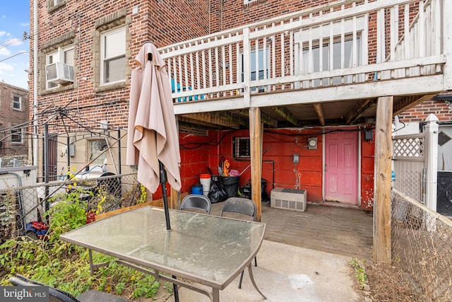 view of patio / terrace featuring cooling unit and a deck