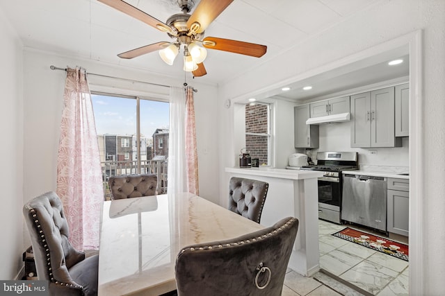 dining area with ceiling fan and ornamental molding