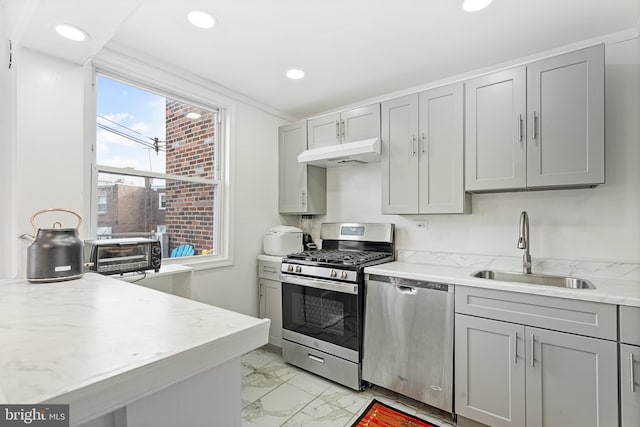 kitchen with gray cabinetry, sink, and stainless steel appliances