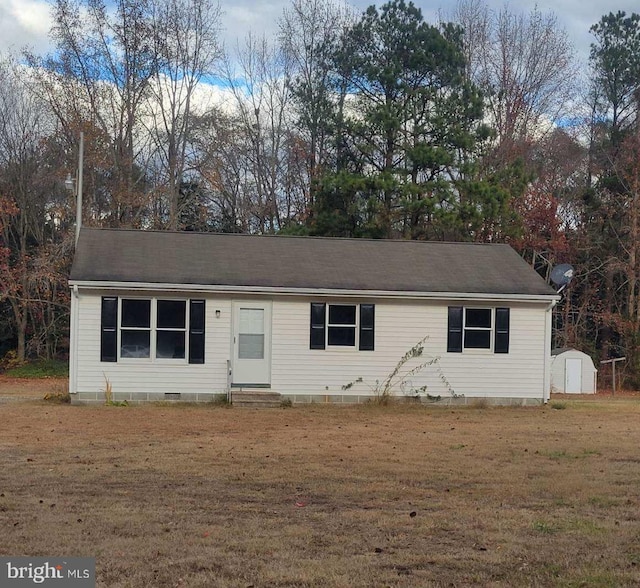 single story home with a storage shed