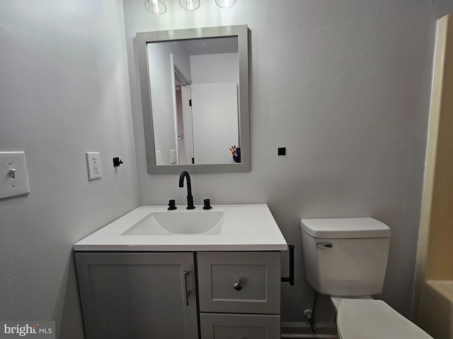 bathroom featuring vanity and toilet