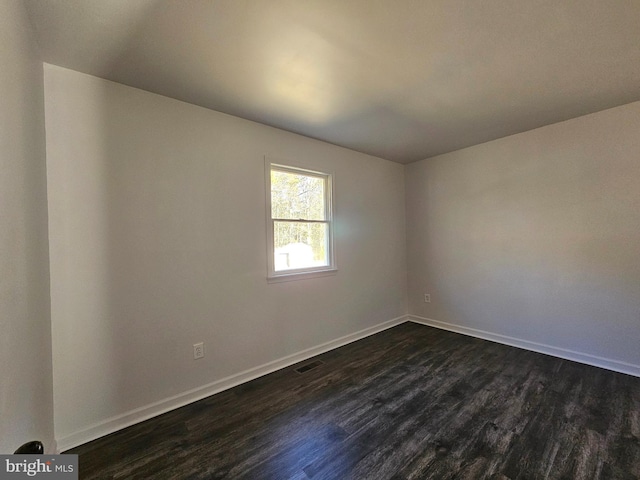 empty room with dark hardwood / wood-style floors