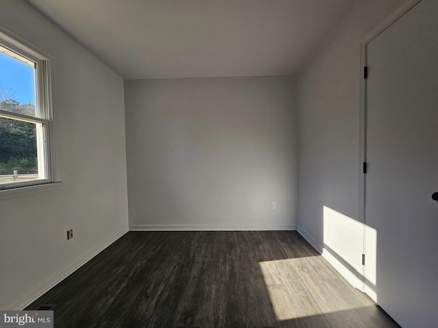 unfurnished room featuring dark hardwood / wood-style floors