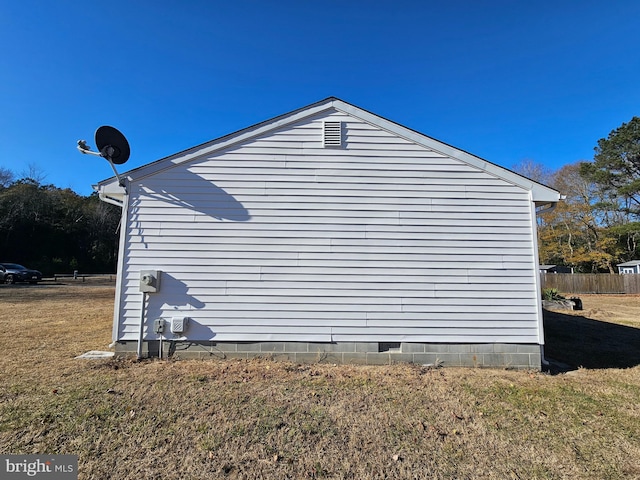 view of side of home with a lawn