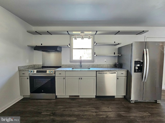 kitchen with ventilation hood, sink, light stone countertops, appliances with stainless steel finishes, and dark hardwood / wood-style flooring