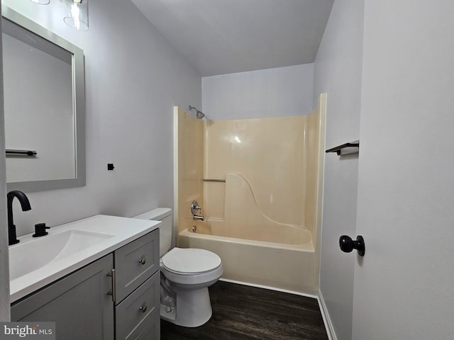 full bathroom featuring hardwood / wood-style floors, vanity, toilet, and shower / washtub combination