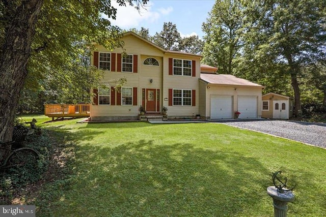 colonial house with a garage, a front lawn, and a wooden deck