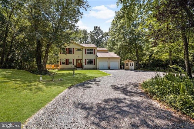 view of front of house with a front lawn and a garage