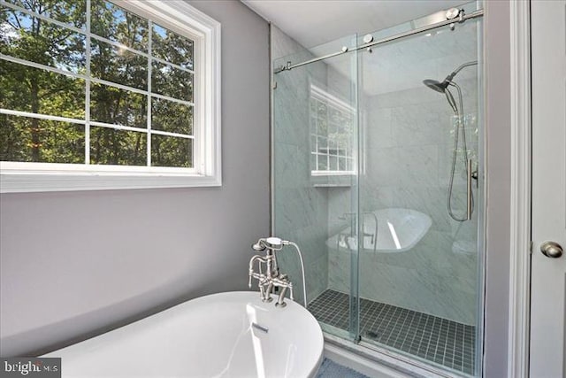 bathroom with shower with separate bathtub