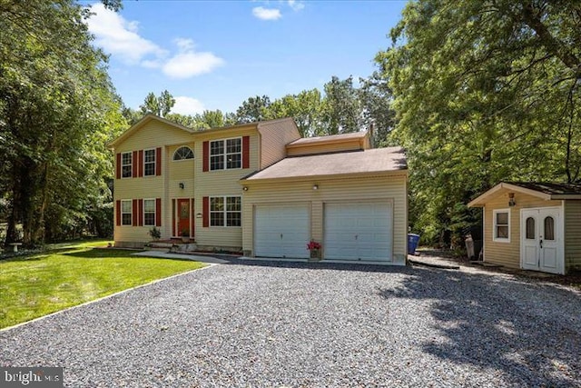 colonial house with a garage and a front yard