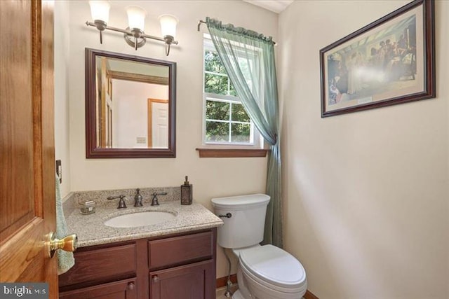 bathroom featuring vanity and toilet