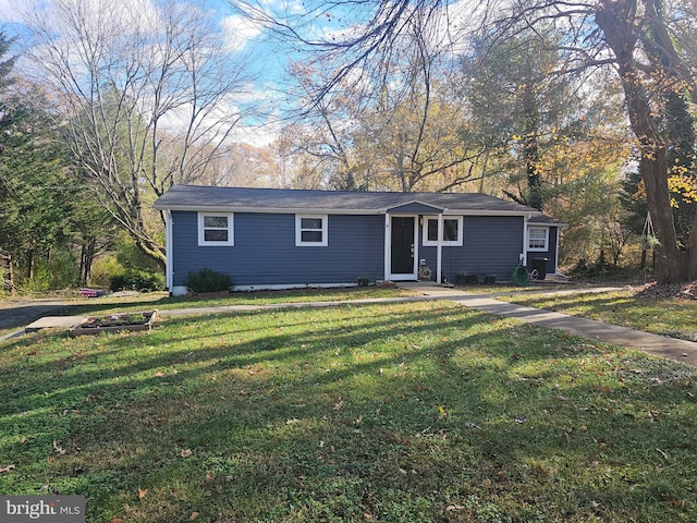 single story home featuring a front yard