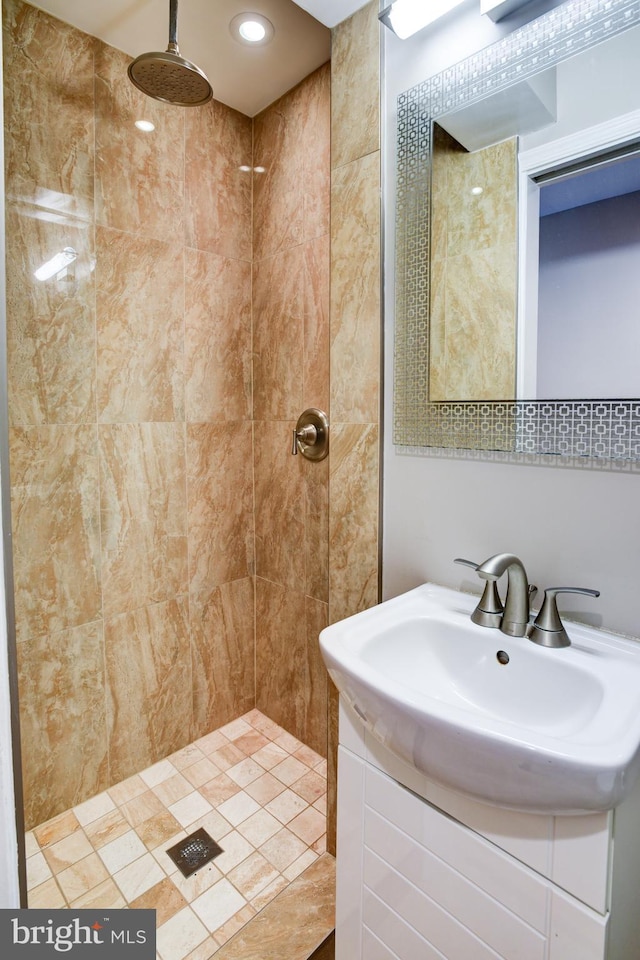 bathroom featuring vanity and tiled shower