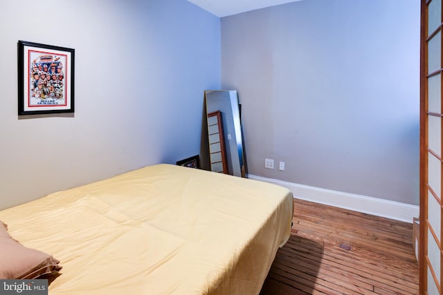 bedroom with hardwood / wood-style flooring