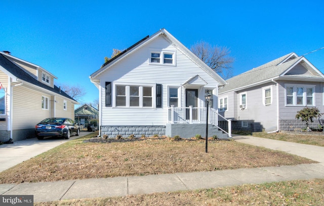 bungalow-style home featuring a front yard