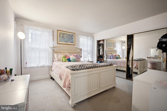 carpeted bedroom with multiple windows and a closet