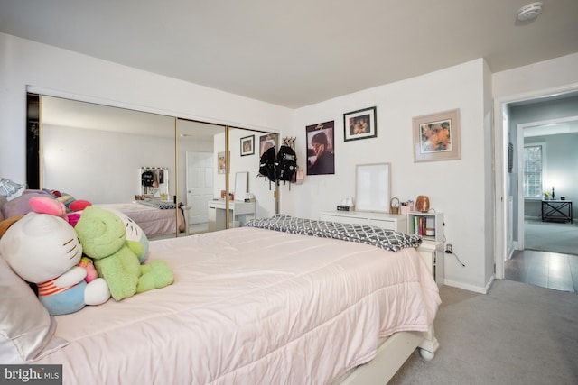 bedroom with light carpet and a closet