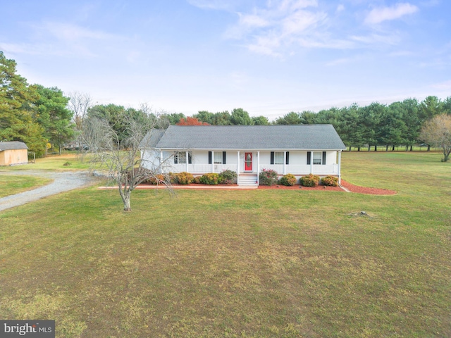 single story home featuring covered porch and a front yard