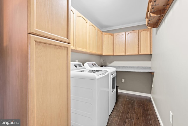 laundry area featuring ornamental molding, cabinets, washing machine and dryer, and dark hardwood / wood-style flooring