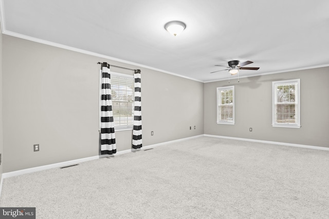 spare room with crown molding and ceiling fan