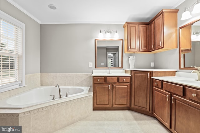 bathroom with tiled bath, vanity, and crown molding