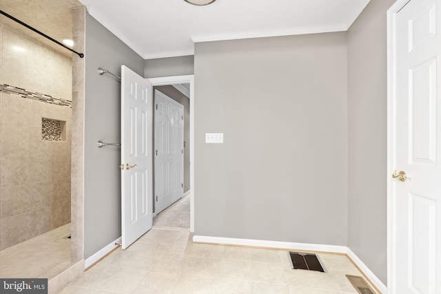 corridor with crown molding and light tile patterned flooring