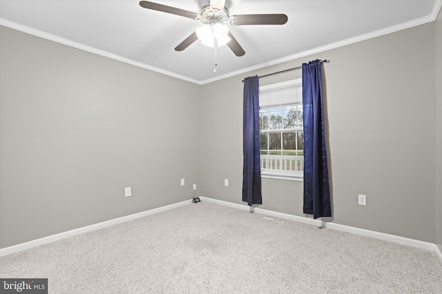 spare room featuring ceiling fan, ornamental molding, and carpet flooring