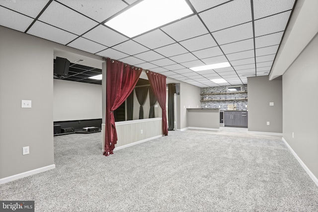 basement with carpet floors and bar area