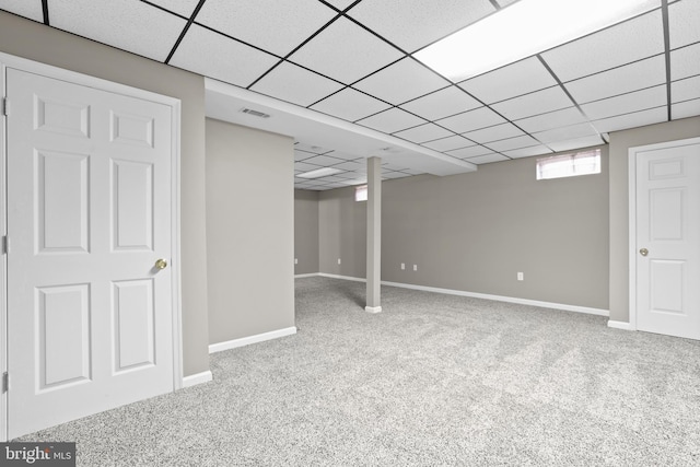 basement with carpet floors and a drop ceiling