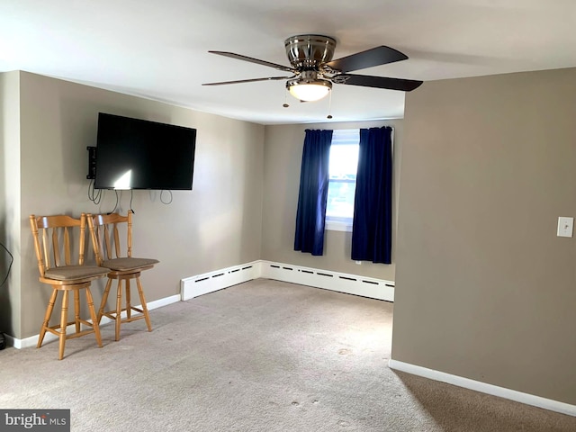 unfurnished living room with ceiling fan, carpet floors, and a baseboard heating unit