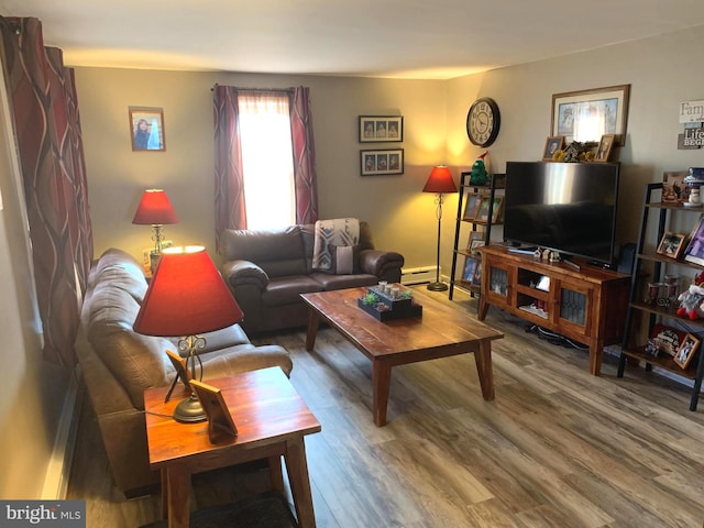 living room with wood-type flooring and a baseboard heating unit