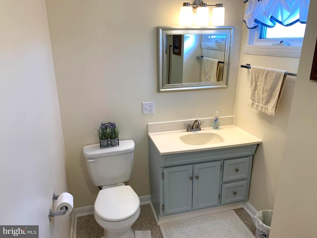 bathroom with tile patterned flooring, vanity, and toilet