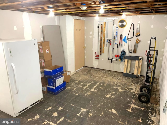 basement with white fridge