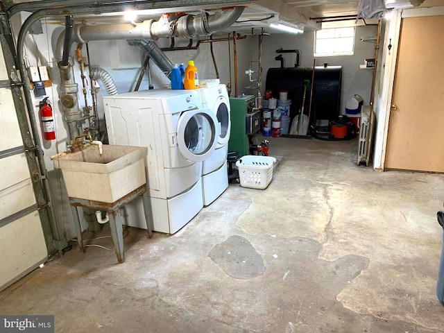 clothes washing area with washer and dryer and sink