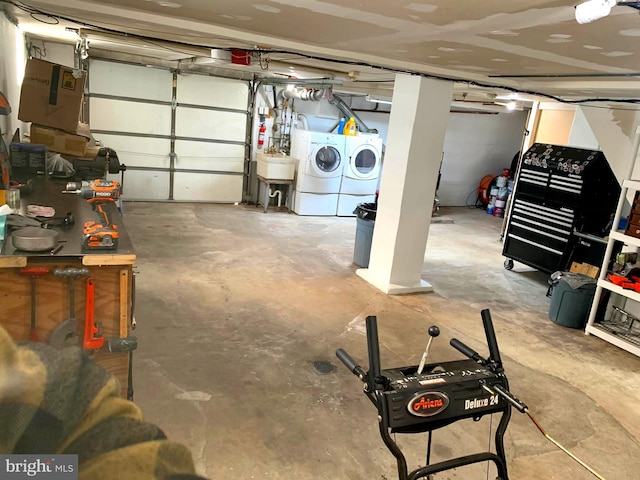 garage featuring washer and dryer and sink