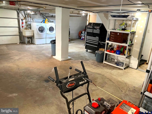 basement featuring washer and clothes dryer and sink