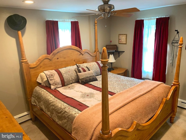 carpeted bedroom with ceiling fan and a baseboard radiator