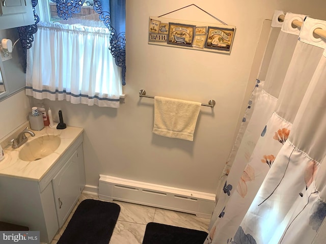 bathroom with vanity and a baseboard heating unit